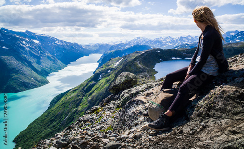 Young, hiking woman looks into the Jotunheimen mountains. Norway
