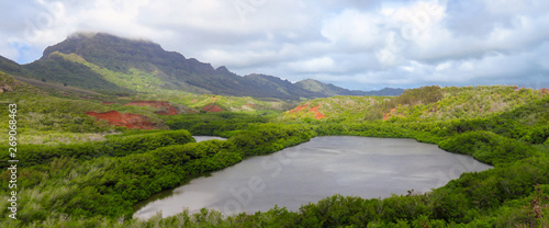 Panoramic view of Menehune fish pond aka Alekoko Fishpond on a bright summer day, mountains in the background, near Lihue, Kauai, Hawaii, USA