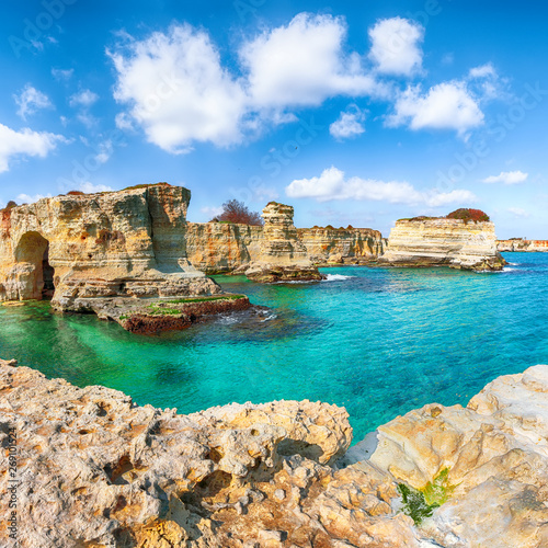Picturesque seascape with cliffs, rocky arch at Torre Sant Andrea