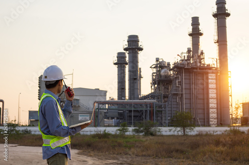 Engineer working and laptop at power plant