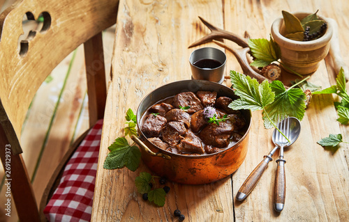 Vintage copper pot with spicy venison goulash