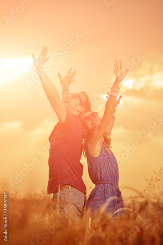 Couple in sunset / sunrise time in a wheat field.