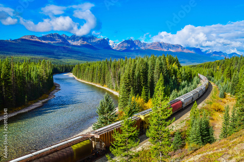 Long freight train moving along Bow river in Canadian Rockies ,Banff National Park, Canadian Rockies,Canada. 