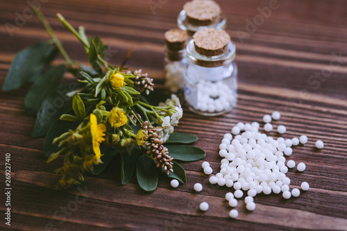 Homeopathic globules in small bottles, homeopathy concept