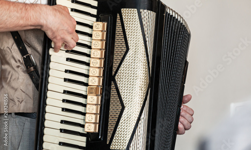 Accordionist plays accordion, close up