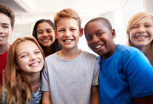 Portrait Of Smiling Male And Female Students In Grade School Classroom