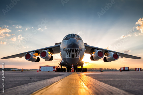 Wide body transport cargo aircraft at airport apron in the morning sun