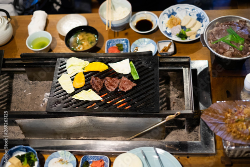 Japanese lunch with hida beef prepared on grill, Hida Beef Sukiyaki and Hida beef on oba leaf with miso in Takayama, Japan.