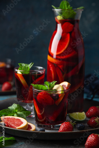 glass of homemade red wine sangria with fruits and berries