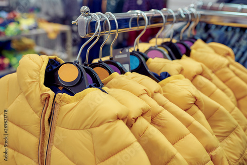 Kids jackets on hangers in an outlet.