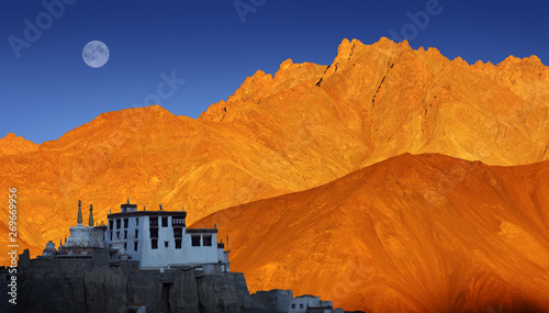 Lamayuru Buddhist monastery, scenic mountain view with full moon and sunset, Ladakh, India