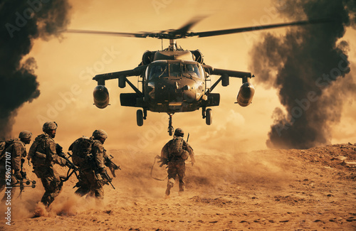 Military soldiers are running to the helicopter in battlefield