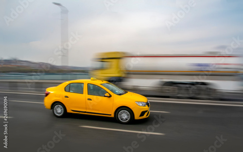 Evening traffic long exposure yellow turkish taxi car on istanbul 