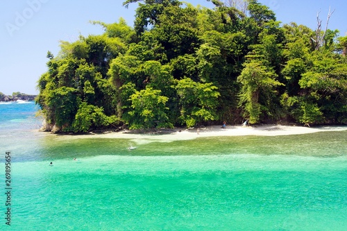 View on secluded islet with white sand and turquoise water - Port Antonio, San San Beach, Jamaica
