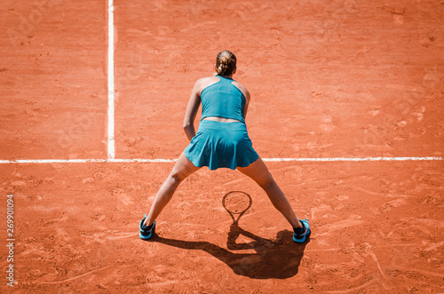 Woman playing tennis receiving service