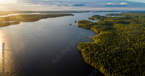 Suoyarvi lake at sunset surrounded by forests of Karelia