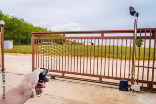 Signal of remote control when person open automatic gate at house system.