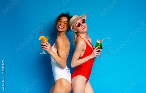 Happy Girls in Swimwear Enjoying Summer Tropical Cocktails