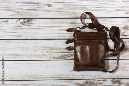 mens leather shoulder bag on wooden background