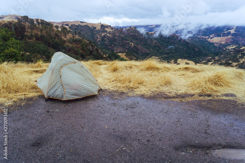 Solitary tent sits on mountain top after rain storm in Sunol region of California