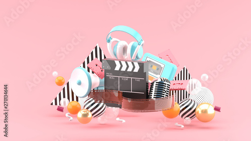 Filmstrip and clapper movies and entertainment on pink blackground.-3d rendering.