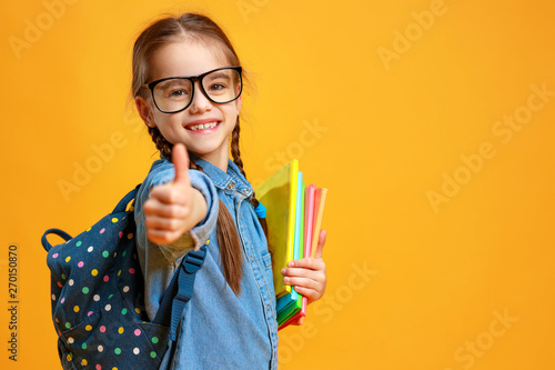 funny child school girl girl on yellow background .