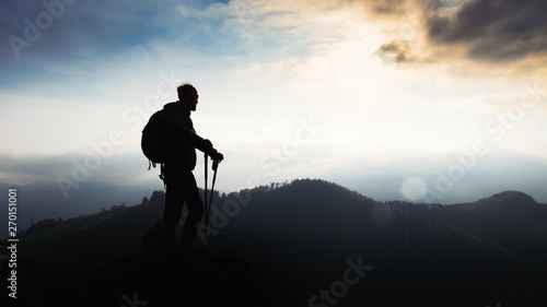 Man during a religious pilgrimage walks at sunset