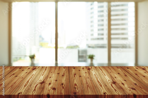 Empty wooden table top with blurred of coffee shop, cafe, bar background, Abstract background can be used for display or montage your products.