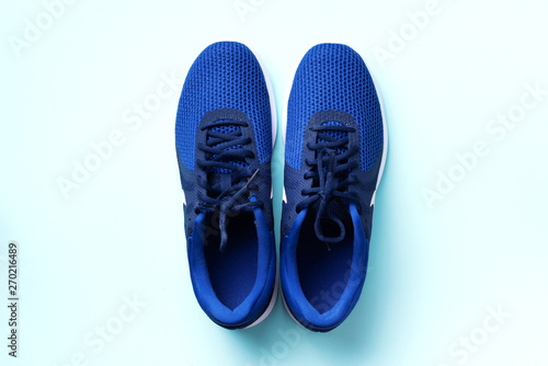 Pair of sport shoes on blue background. Top view, copy space. Fitness, running and sport concept. Healthy lifestyle