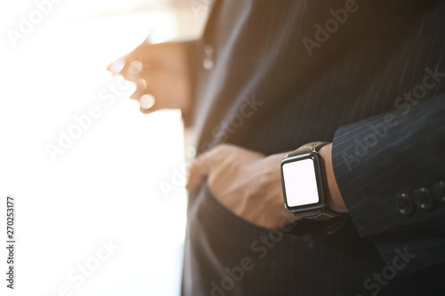 Closeup businessman wearing smart watch on hands.