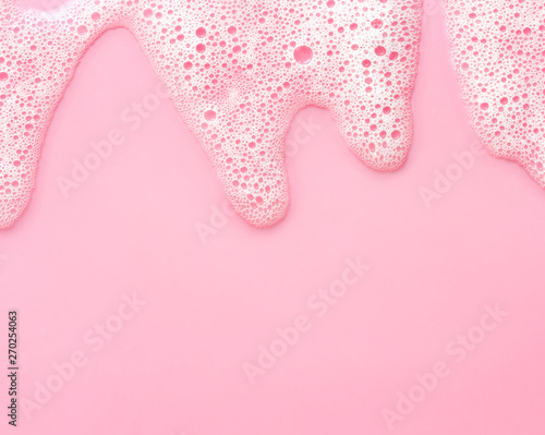 soap foam on delicate pink background with copy space