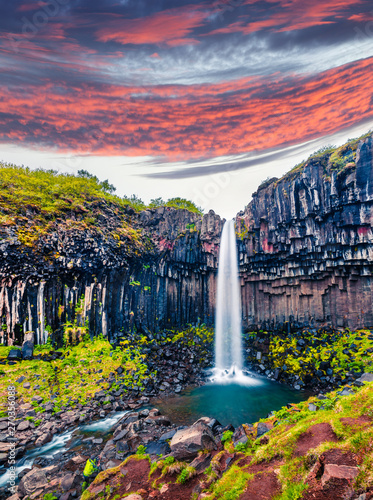 Incredible morning view of famous Svartifoss (Black Fall) Waterfall. Colorful summer sunrise in Skaftafell, Vatnajokull National Park, Iceland, Europe.