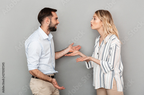 Photo of tense couple in casual clothes discussing problems and arguing