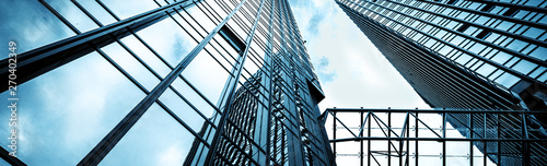 Low angle view of the glass curtain wall of modern city high-rise buildings, Shanghai, China