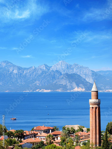 elevated view of cityscape image of historic district of Antalya over Mediterranean sea and high mountains with clear blue sky in Turkey