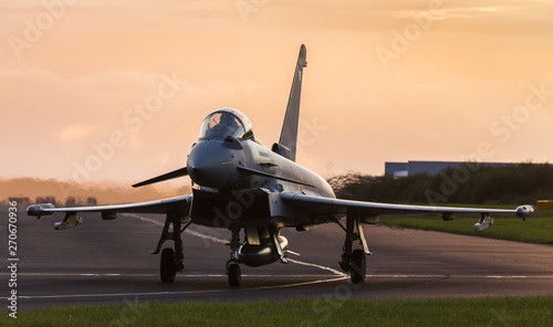 Backlit Typhoon taxis out for takeoff