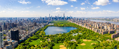 Central Park aerial view, Manhattan, New York. Park is surrounded by skyscraper. Beautiful view of the Jacqueline Kennedy Onassis Reservoir in the center of the park.