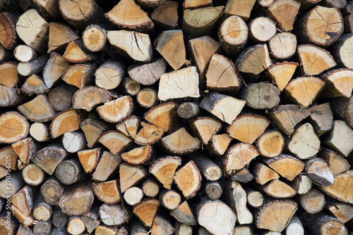 Background of stacked logs stored for fire making