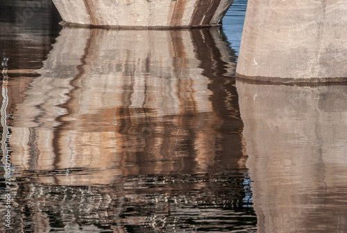 bridge pillar reflected on the water