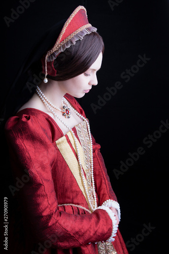 Dark-haired Tudor woman in red dress