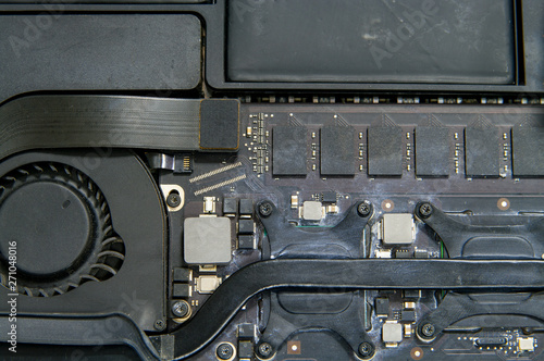 Closeup on laptop inside. Cooling system, memory and battery.