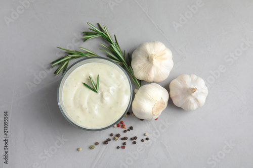 Flat lay composition with garlic sauce on grey background