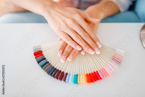 Female hands and colorful nail varnish palette
