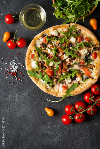Vegetable italian pizza with tomatos on black background