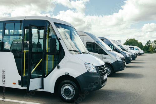 number of new white minibuses and vans outside.