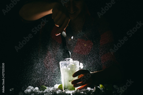 Barman making Mojito and spalshing it out