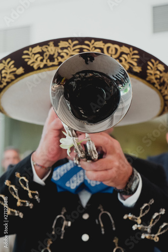 Mexican musician with his trumpet in the foreground, mariachis.