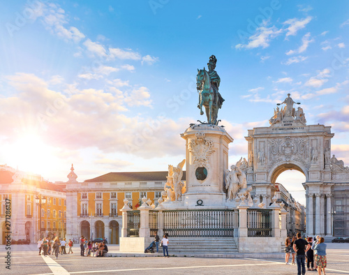 Lisbon, Portugal. King Jose I Statue at Praca do Comercio in front of Triumphal Arch near waterfront. Old town of Lisboa in historic midtown Alfama district. Evening sunset and blue sky with clouds.