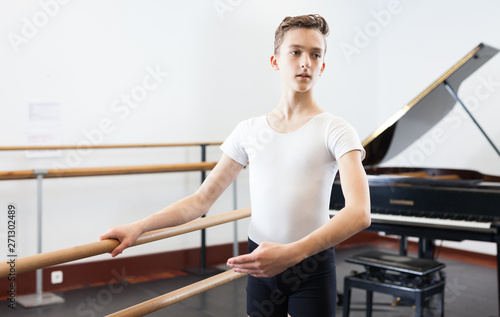 Young dancer practicing at the ballet barre
