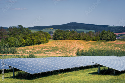 Solar farm with photovoltaic panels at sunset